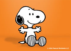 Snoopy the dog from the Peanuts cartoon sits in front of an orange background