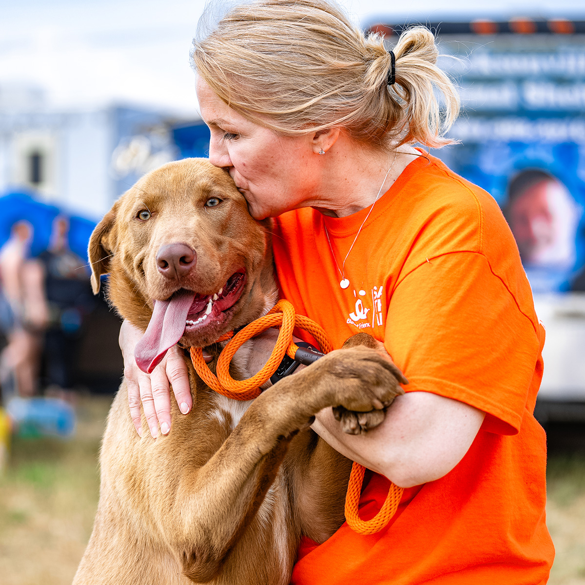 Woman hugging a brown dog